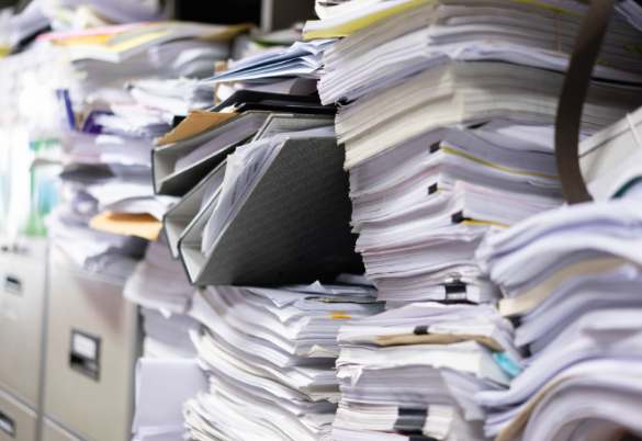 Pile of paper tickets that Dump Truck Dispatcher eliminates